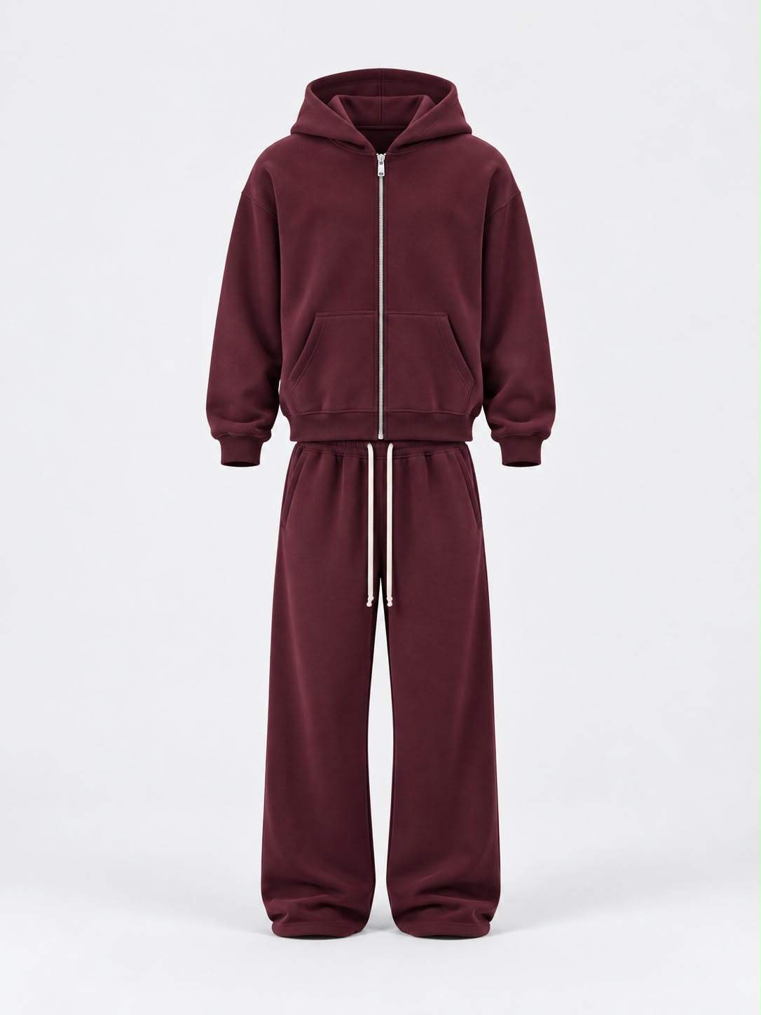 Tuta Felpata con zip in morbido tessuto felpato bordeaux, composta da felpa con cappuccio e pantaloni larghi con coulisse.